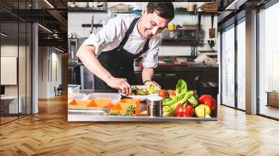 professional chef cooking in the kitchen restaurant at the hotel, preparing dinner. a cook in an apr Wall mural