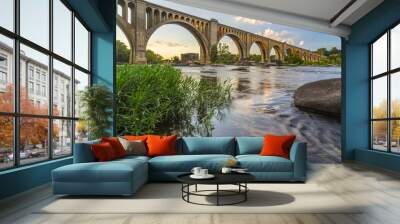 Richmond Railroad Bridge Lit by Sun/ The graceful arches of a railroad bridge spanning the James River in Virginia are illuminated by the setting sun. Wall mural