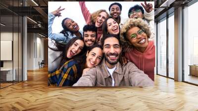 Big group portrait of diverse young people together outdoors - Multiracial happy millennial male and female friends having fun together - Unity and friendship concept - Focus on man in the center Wall mural