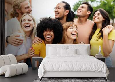 Diverse group of young friends having fun together outside. Millennial student people laughing and having fun enjoying holiday. Youth community and friendship concept. Wall mural