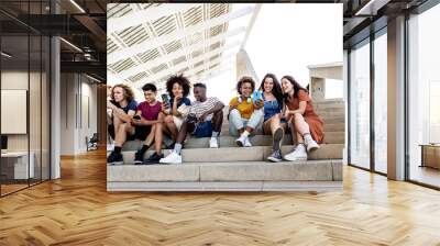 Group of diverse hipster friends students using mobile phone outdoors - Multiethnic young teenagers people from different cultures sharing content on social networks - Technology addiction and youth Wall mural