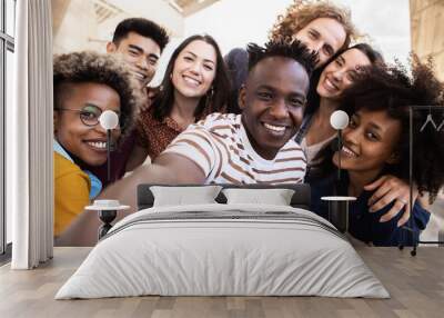 Group of happy young people taking selfie portrait together outdoor - Millennial diverse united best friends student having fun on vacation - Community, friendship and unity concept Wall mural