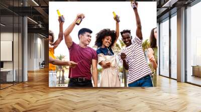 Group of multiracial young friends having fun on summer party - Millennial people celebrating together with sparkles cheering with beers - Vacation and friendship concept - Focus on african couple Wall mural