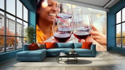 Group of young people toasting red wine at summer rooftop night party. Multiracial friends celebrating together at home terrace. Vertical photo. Wall mural