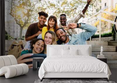 Multiracial young happy group of student friends taking selfie portrait together using mobile phone outdoors Wall mural