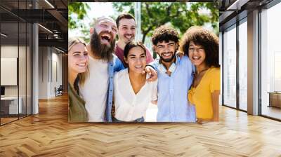 Portrait group of happy multiracial young friends hugging each other outdoors - International friendship concept Wall mural