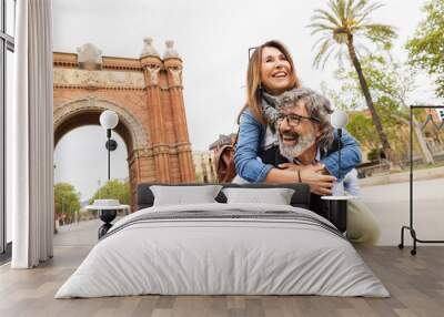 Senior couple in love having fun in Barcelona city on summer holiday. Lifestyle retirement and vacation concept Wall mural