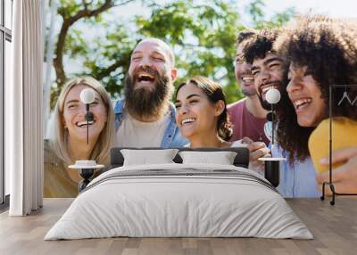 Young group of diverse friends having fun in a sunny day - Multiracial best friends enjoying time together outdoors - United millennial people laughing Wall mural