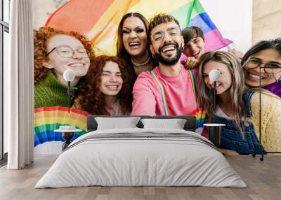 Young group of friends with rainbow flags celebrating gay pride day festival together. LGBT community people concept. Wall mural