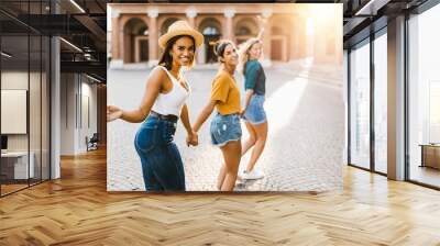 Young group of happy women having fun together on Italy during summer vacation - Joyful female friends running running in old town in an italian city - Happiness, friendship and holidays concept Wall mural