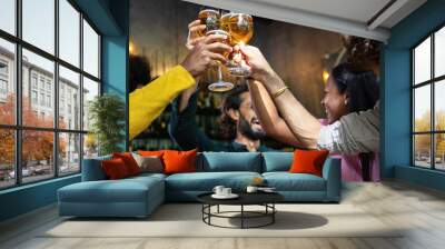 Young group of multiracial people toasting cold beer at happy hours brewery bar. After work concept Wall mural