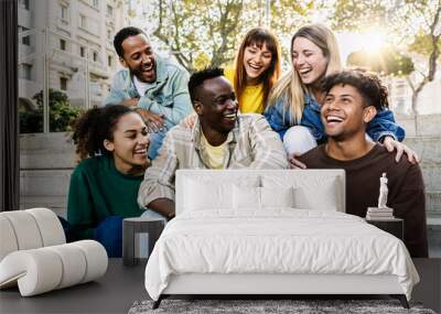 Young group of student friends having fun relaxing together outdoors. Millennial college people sitting together on urban stairs enjoying conversation. Digital detox and youth community concept. Wall mural