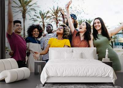 Young multiracial hipster people having fun in summer party celebration - Group of young friends laughing and celebrating all together while throwing coloured confetti at weekend event outdoors Wall mural