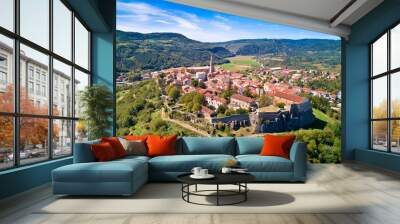 Buzet. Hill town of Buzet surrounded by stone walls in green landscape aerial view. Wall mural