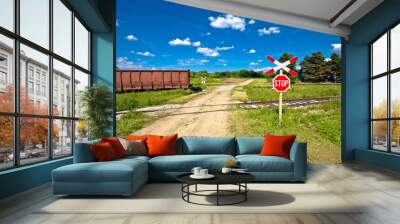 Unprotected railroad crossing country road view. Wall mural