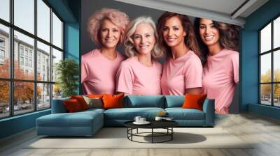 studio shot of a group of smiling women in pink clothes are posing together Wall mural