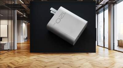 A phone charger  on a black background
 Wall mural