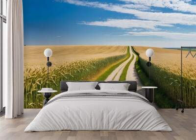 A winding country road through golden fields of wheat, under a wide, clear blue sky. The landscape stretches to the horizon, evoking a sense of freedom and open space Wall mural