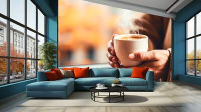 A woman is holding mug of hot coffee. Warming drink in female hands. Copy space Wall mural