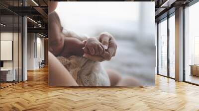 Close up Mother holding hands Asian female newborn baby  and sunlight in the morning. Cute little girl  three weeks old. Health, care, love, relationship concept. Wall mural