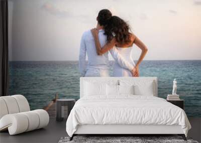 Sensual happy couple in white clothes on a pier (Maldives) Wall mural