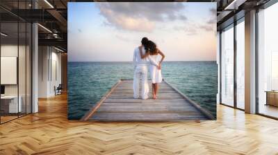 Sensual happy couple in white clothes on a pier (Maldives) Wall mural