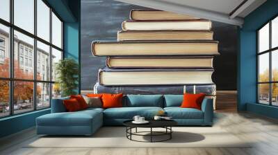 A Stack of Books on a Wooden Table Wall mural