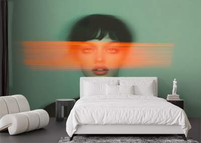 Abstract portrait of a girl with an orange crossed out line on her face, a red ribbon on her face on top of the photo. On a gray-turquoise background, in motion, double exposure Wall mural