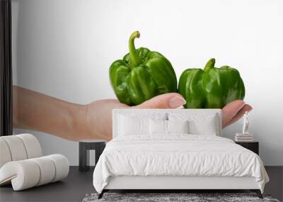 closeup of holding two fresh green pepper in hand with white background Wall mural