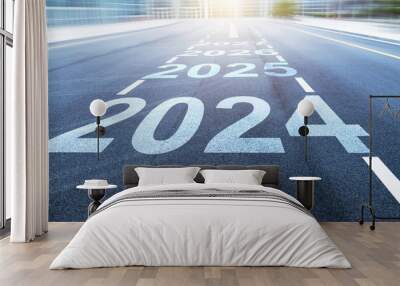 Black asphalt road with new year numbers 2024, 2025 to 2027 with white dividing lines Wall mural