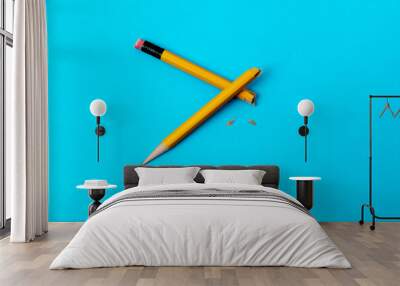 Broken pencil on blue background Wall mural