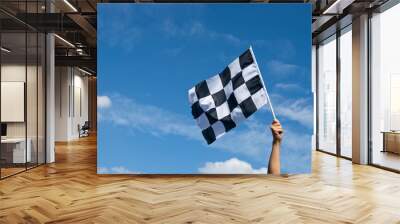 checkered race flag in hand. Wall mural