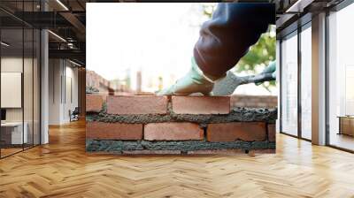 Close up of bricklayer building walls Wall mural