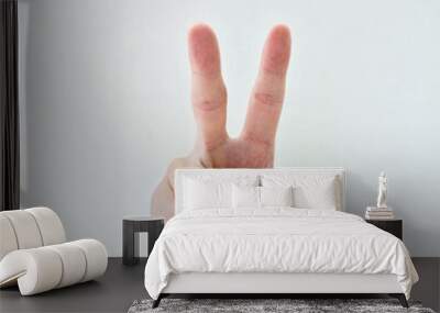 Hand pointing two fingers break through white paper Wall mural