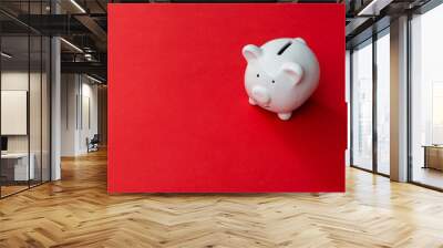 Piggy bank on red background Wall mural