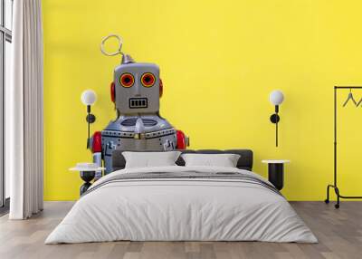 Retro robot toy on yellow background Wall mural