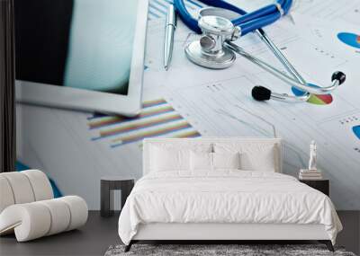 Stethoscope and digital tablet on report chart paper Wall mural