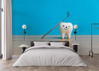 Tooth model and dentist mirror on table Wall mural