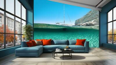 Sailboat anchored at white cove, half under water shot. Wall mural