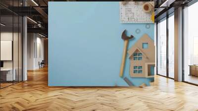 Construction Tools and House Model on Blue Background Wall mural