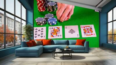  Poker player placing chips on the table during a round of betting during a game of Texas Holdem poker Wall mural