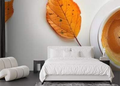 cup of coffee with autumn leaf on white background. Wall mural