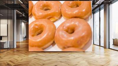 Bakery fresh soft and sweet delicious glazed donuts in box Wall mural