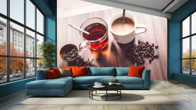 Coffee and tea with coffee bean and tea leaves on wooden floor. Wall mural