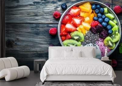 Overhead photo of a healthy breakfast bowl with colorful vegetables, seeds, t, arranged beautifully on a wooden table Wall mural