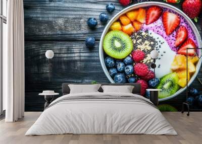 Overhead photo of a healthy breakfast bowl with colorful vegetables, seeds, t, arranged beautifully on a wooden table Wall mural