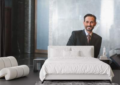 Adult businessman awaiting checking into hotel Wall mural