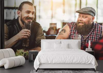 Adult joyful men spending evening in bar Wall mural