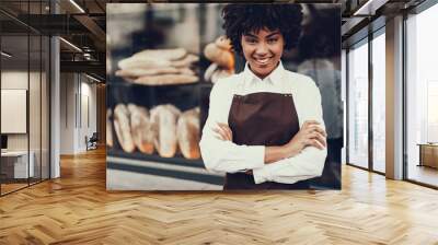 Attractive lady standing near bakery shop and smiling Wall mural