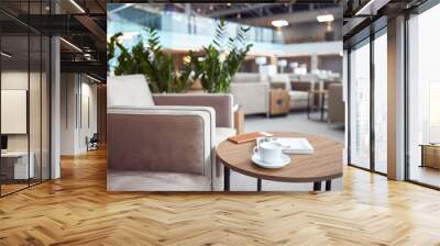 Cappuccino, book and wallet on table at departure lounge Wall mural